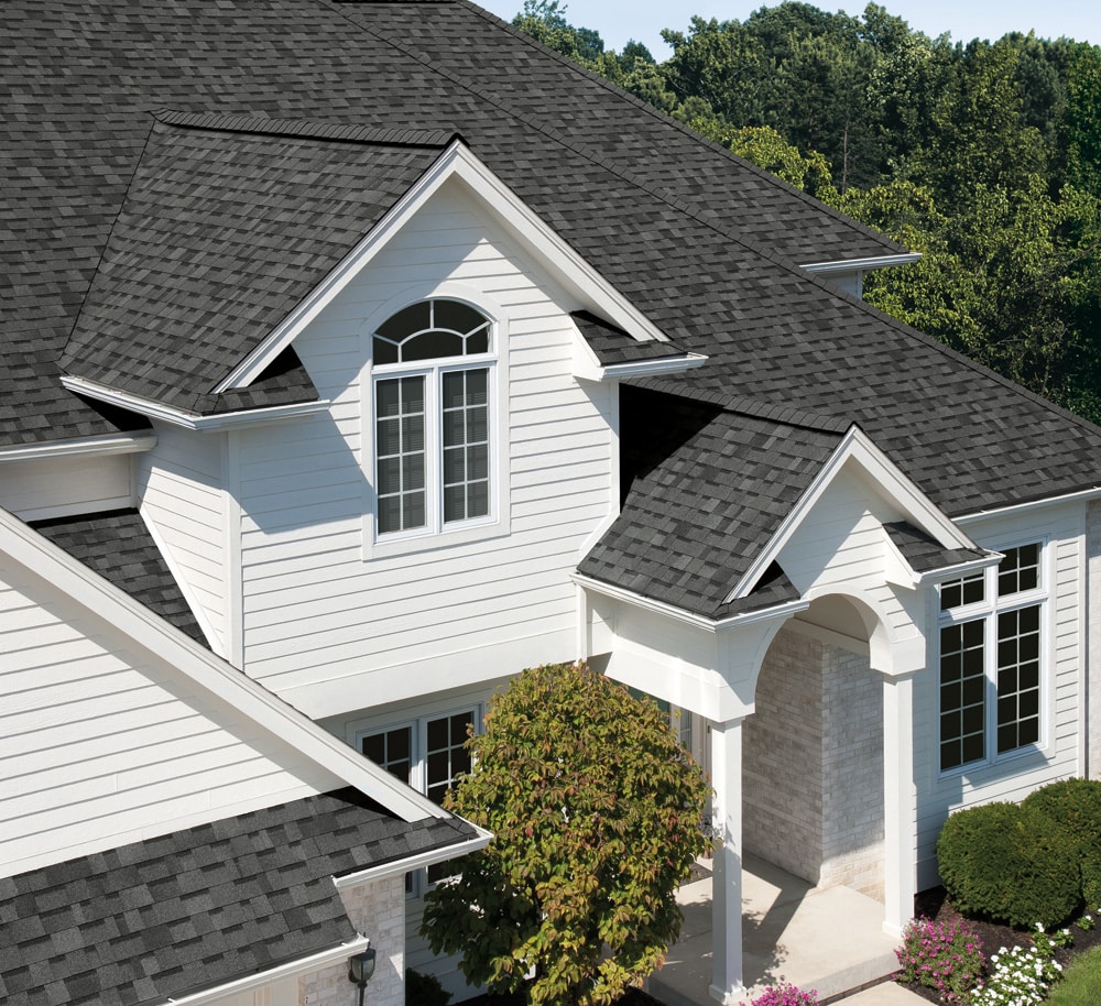 aerial shot of a dark gray shingle roof on a white house